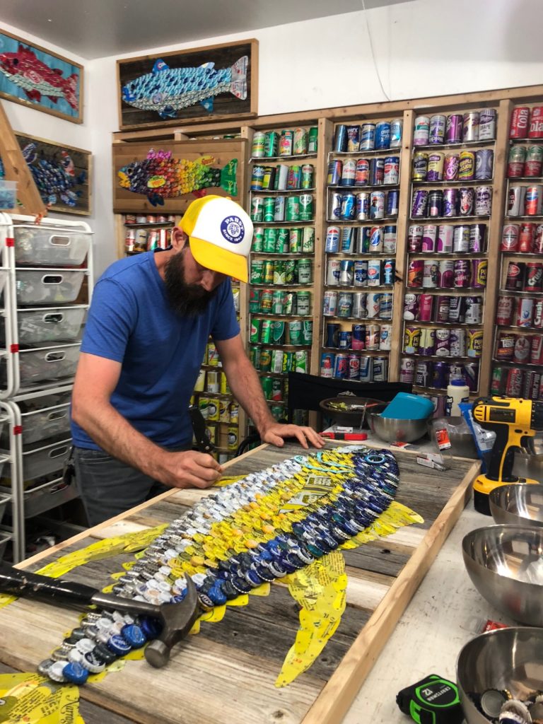 Alan Moore creating bottle cap art in his studio