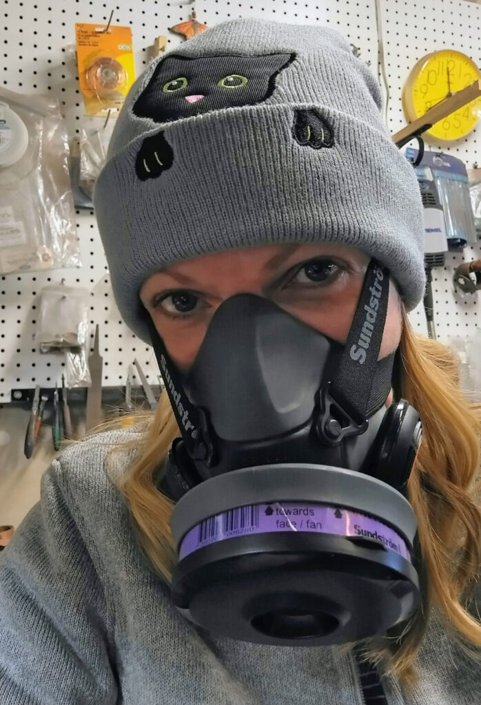 Gale wearing protective mask in her studio while making jewelry.