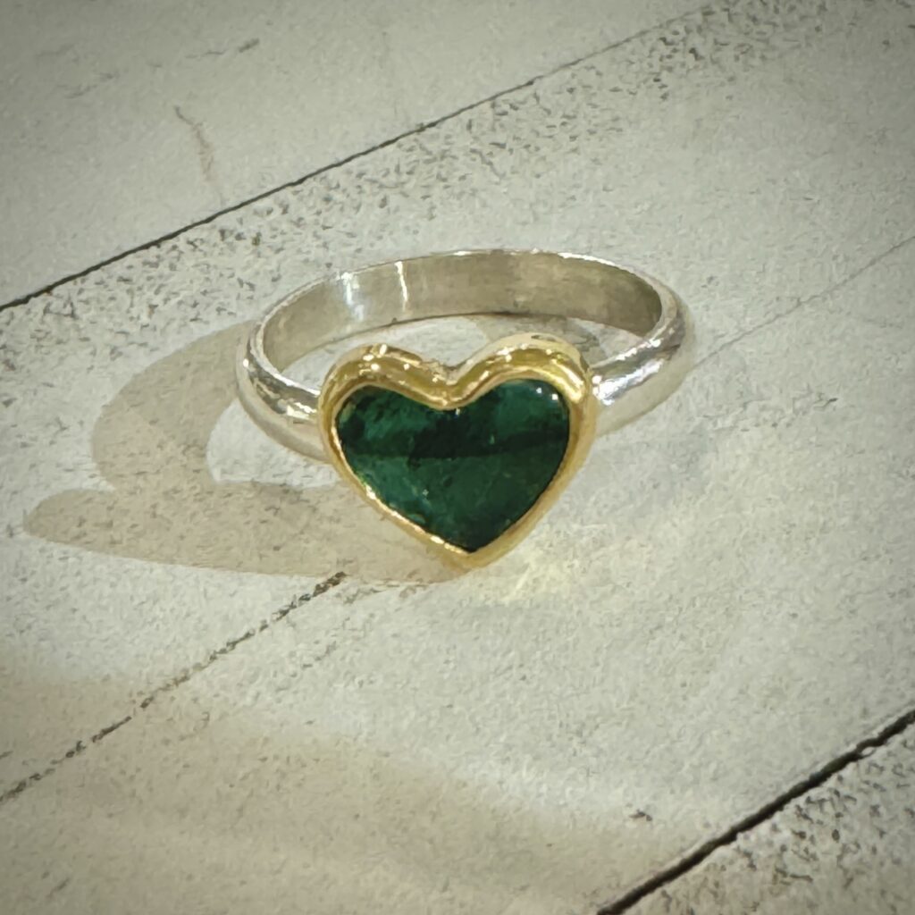 A statement ring. Jewelry made with a Blue Tourmaline Heart surrounded with gold around the heart gemstone.