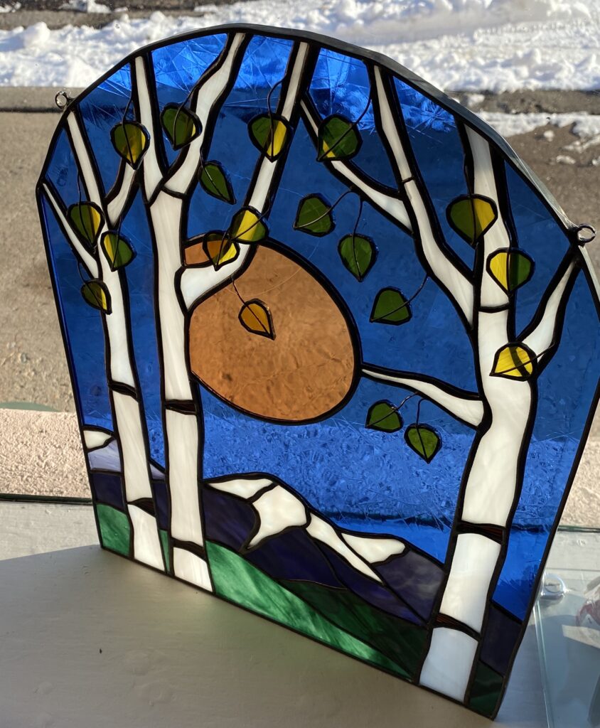 Stained Glass window panel with aspen trees, moon and mountains by artist Susan Peppel
